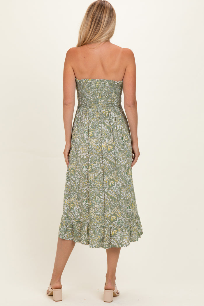 woman wearing a green floral strapless midi dress with a smocked bodice and ruffled hemline, viewed from the back