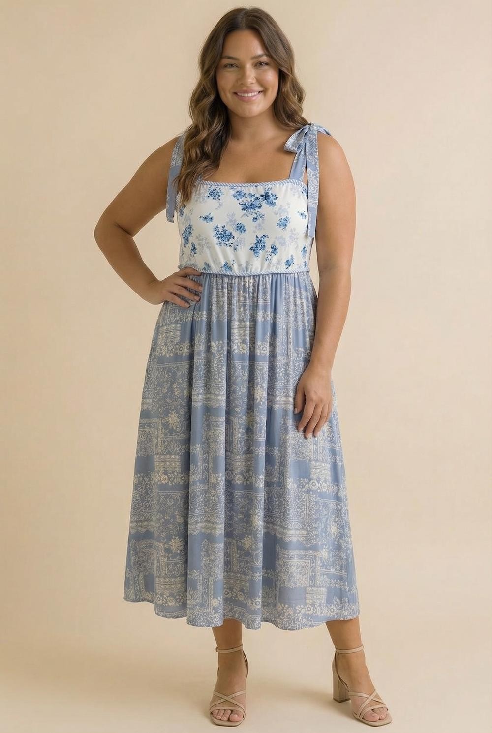 woman wearing a blue and white floral midi dress with tie straps and a relaxed fit