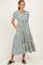 woman wearing a striped tiered midi dress with puff sleeves and pockets, standing and smiling