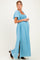 woman wearing a light blue maternity maxi dress with a smocked bodice and flutter sleeves, showing her baby bump