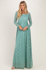 woman wearing a teal long sleeve lace maxi dress with a fitted bodice and flowing skirt