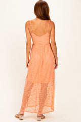 woman wearing a peach maxi dress with a sheer bottom and adjustable spaghetti straps, showing the back view