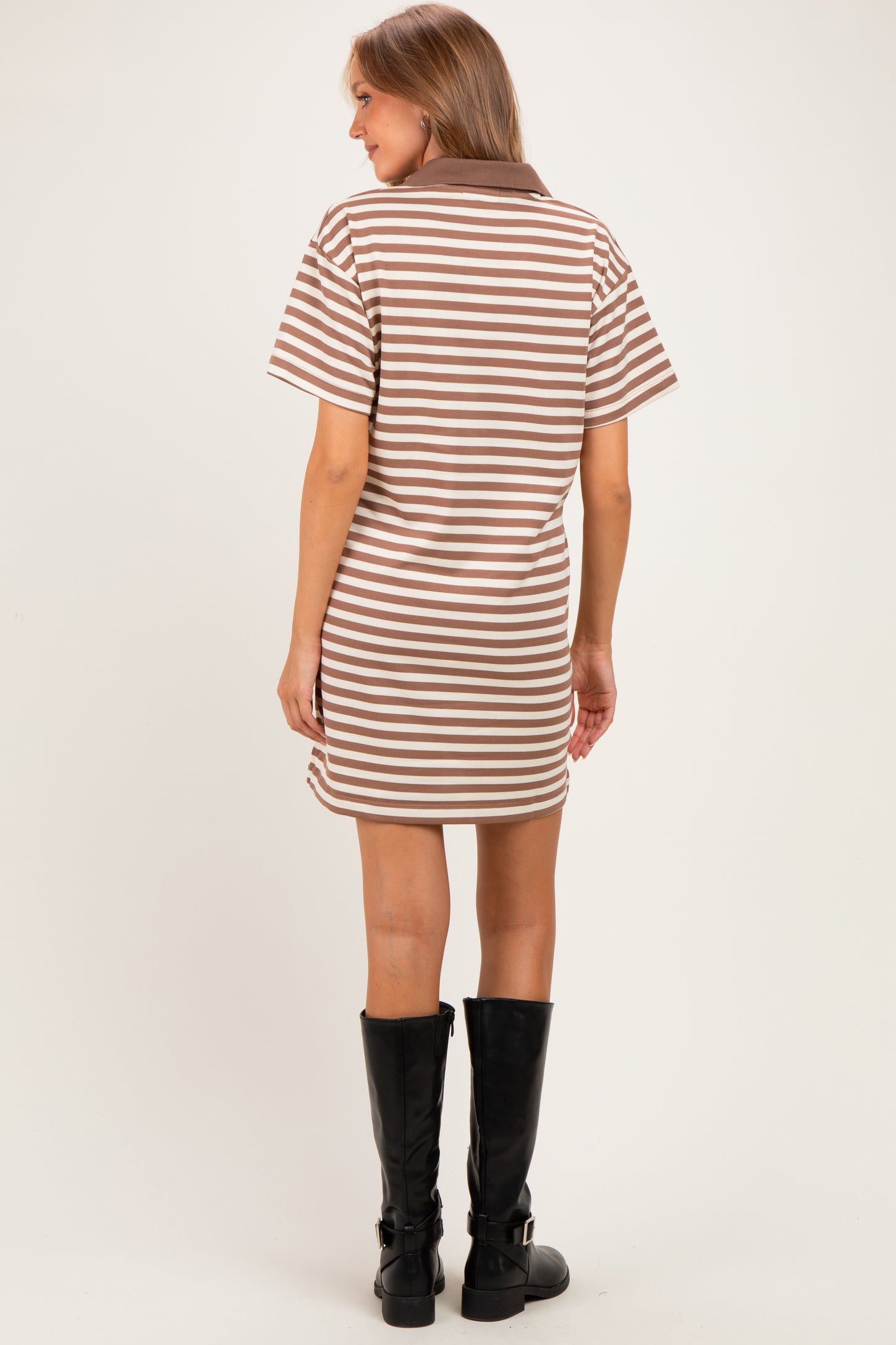woman wearing a brown and white striped maternity polo dress with short sleeves and a relaxed fit