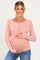 woman wearing a pink and white striped maternity long sleeve top and holding her baby bump