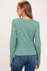 woman wearing a green and white striped long sleeve maternity top, viewed from the back