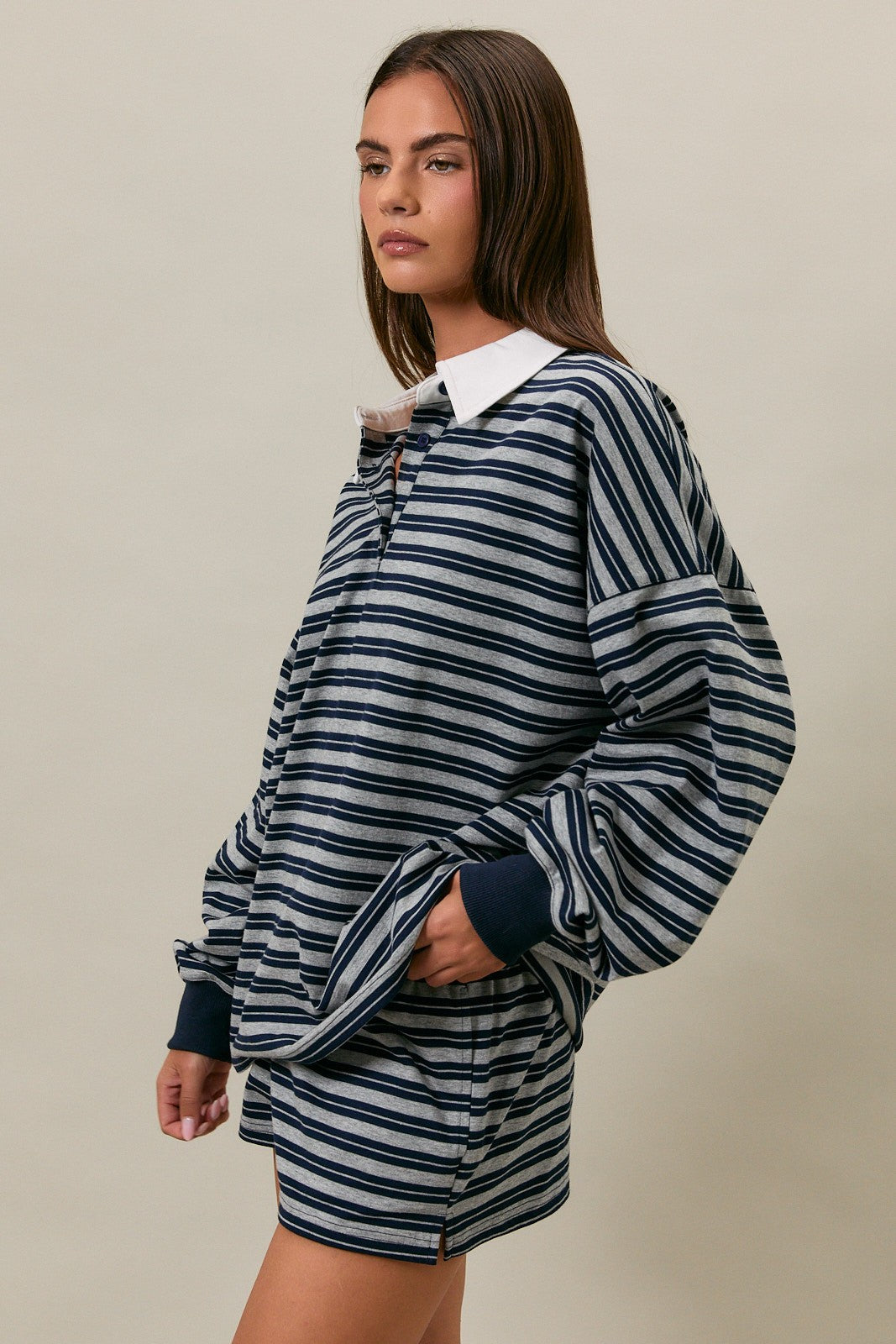 woman wearing a navy and white striped oversized pullover with a collar and matching shorts