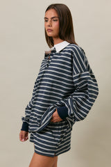 woman wearing a navy and white striped oversized pullover with a collar and matching shorts
