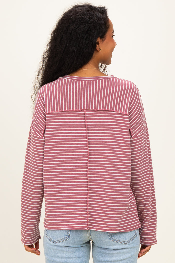 woman wearing a burgundy and white striped maternity top, shown from the back