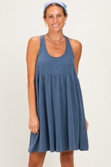 woman wearing a blue striped sleeveless sundress with a flared skirt and a headband in her hair