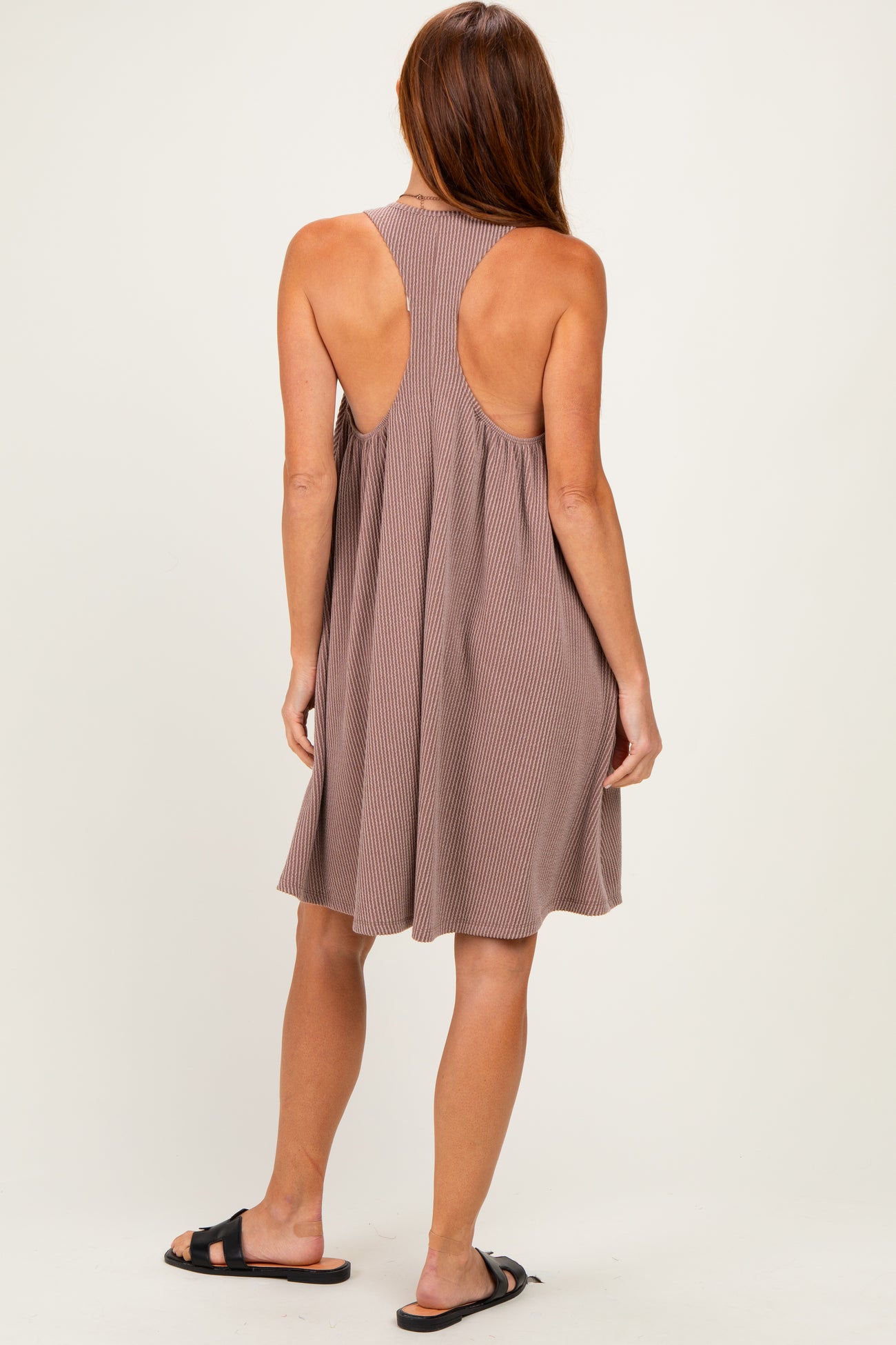 woman wearing a brown ribbed sundress with a racerback design