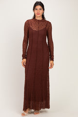 woman wearing a long sleeve brown lace dress with a sheer neckline and fitted silhouette