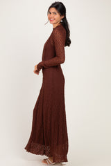 woman wearing a long brown lace maxi dress with long sleeves and a fitted silhouette