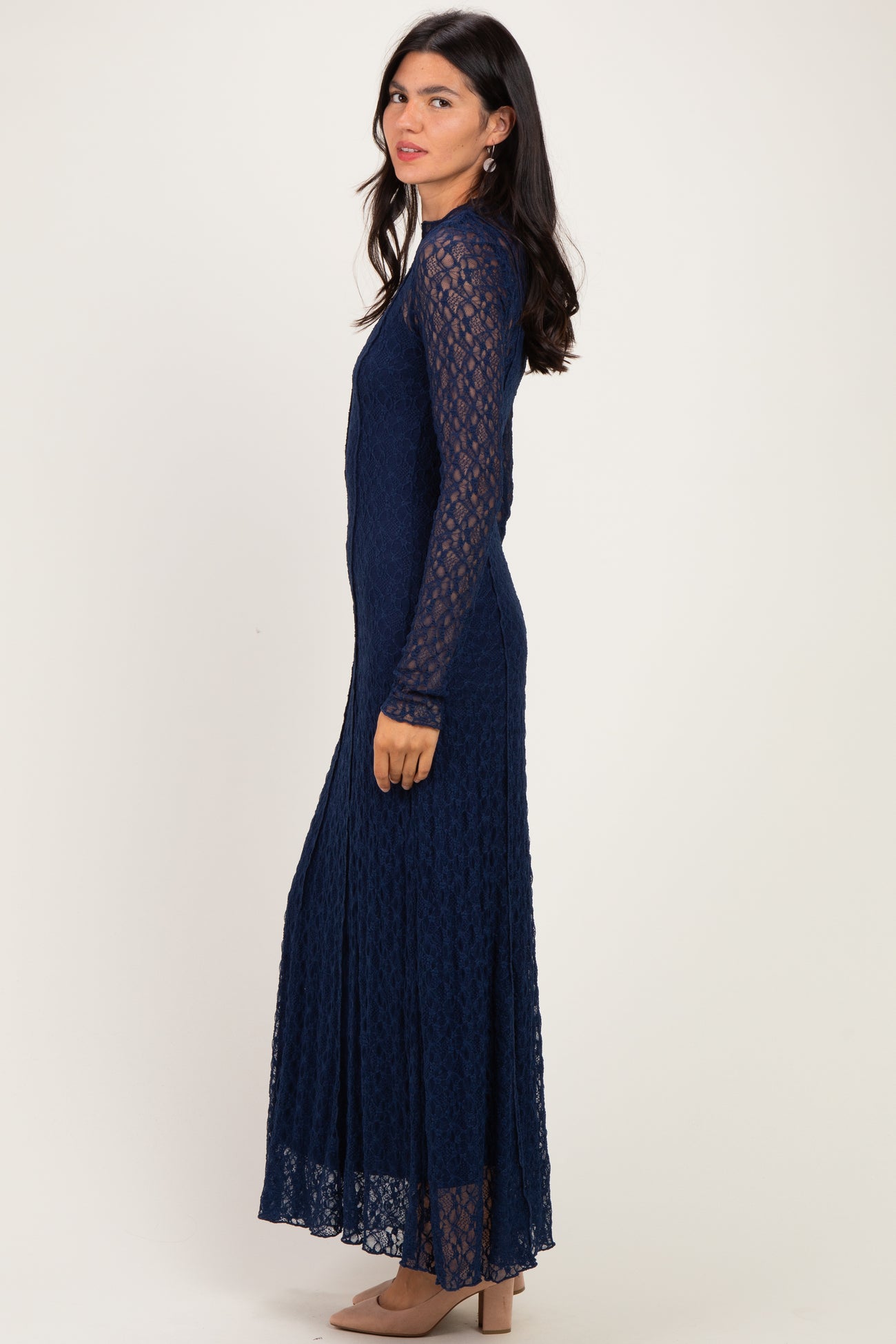 woman wearing a navy blue lace maxi dress with long sleeves and a fitted silhouette