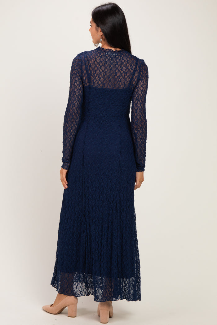 woman wearing a navy blue long sleeve lace maxi dress from the back, featuring a tiered skirt and a fitted bodice