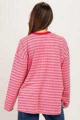 woman wearing a red and pink striped maternity long sleeve top, viewed from the back