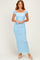 woman wearing a light blue off-the-shoulder maxi dress with ruching details and short sleeves