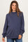 woman wearing a navy blue oversized maternity sweatshirt with a high neck and balloon sleeves, baby bump visible
