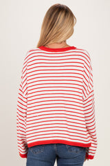 woman wearing a red and white striped oversized sweater, back view, with loose fit and dropped shoulders