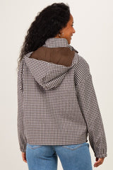 woman wearing a brown and white checkered maternity jacket with a hood, seen from the back