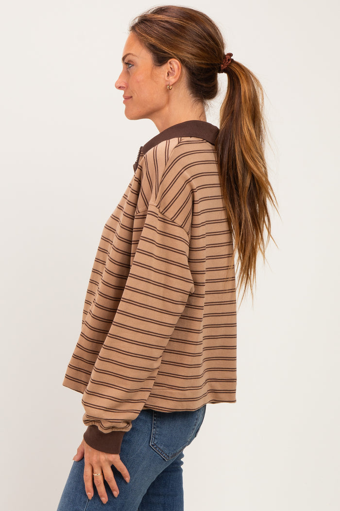 woman wearing a brown striped pullover sweatshirt with a zip collar and long sleeves, styled casually with jeans
