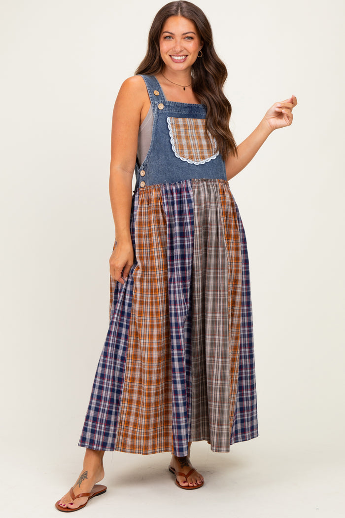 woman wearing a denim and plaid maternity dress with a fitted top and flowy skirt, showcasing a baby bump