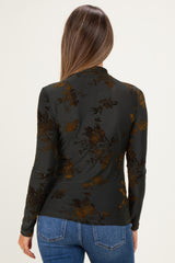 woman wearing a dark floral maternity top with long sleeves, seen from the back, paired with blue jeans