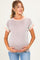 woman wearing a striped maternity top in pastel colors with a baby bump visible, holding her stomach
