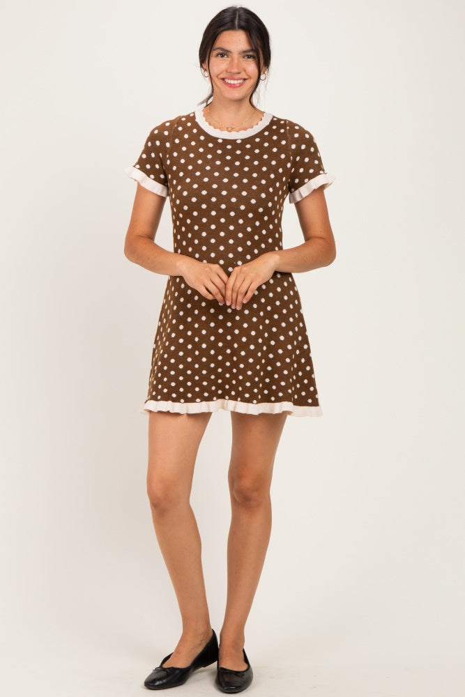 woman wearing a brown polka dot dress with short sleeves and ruffled hem