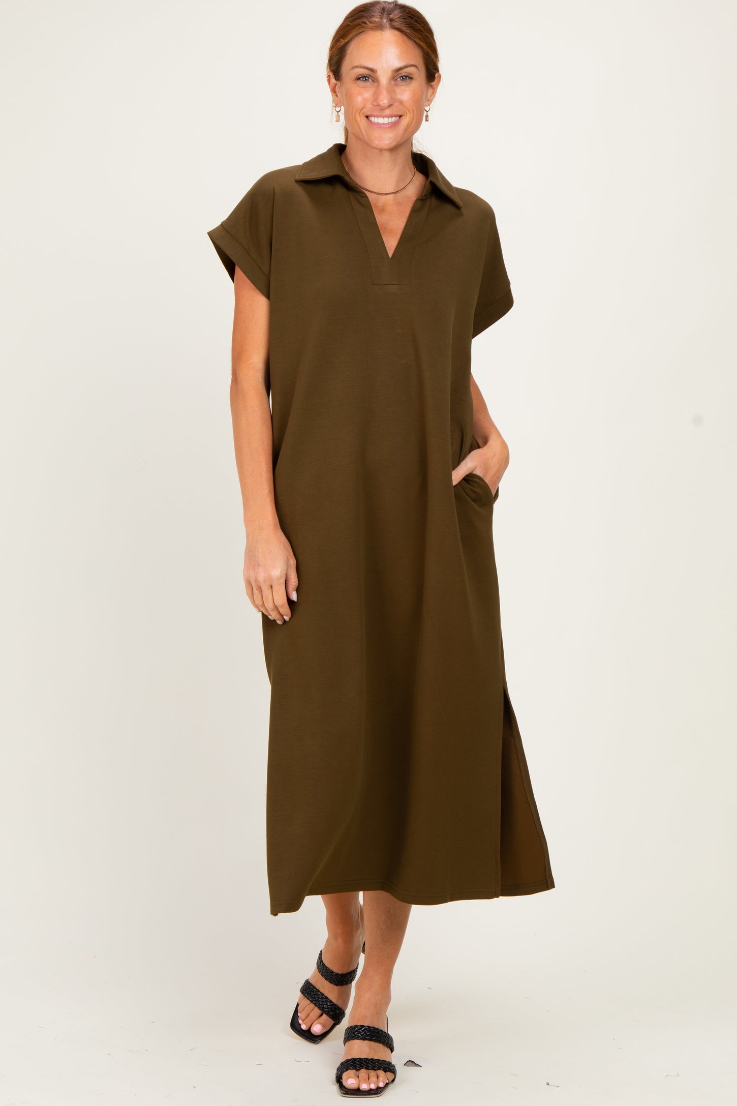 woman wearing an olive green short sleeve maxi dress with a collar and side pockets