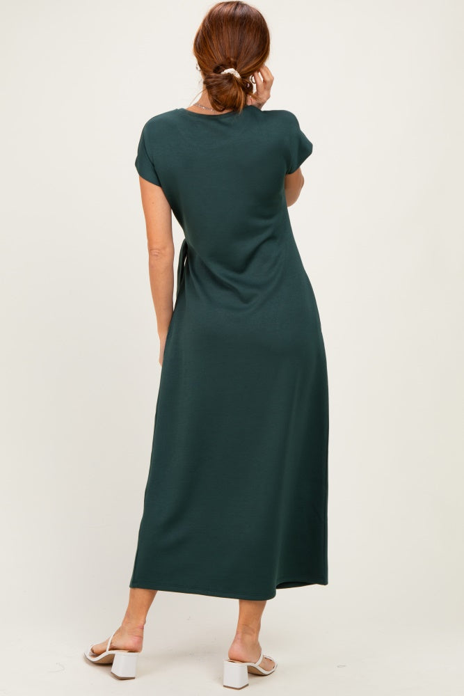 woman wearing a dark green cap sleeve maxi dress, viewed from the back