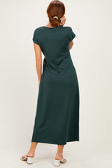 woman wearing a dark green cap sleeve maxi dress, viewed from the back