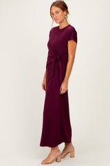 woman wearing a burgundy maxi dress with a tie waist detail and short sleeves
