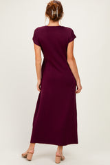 woman wearing a burgundy maxi dress with short sleeves, view from the back