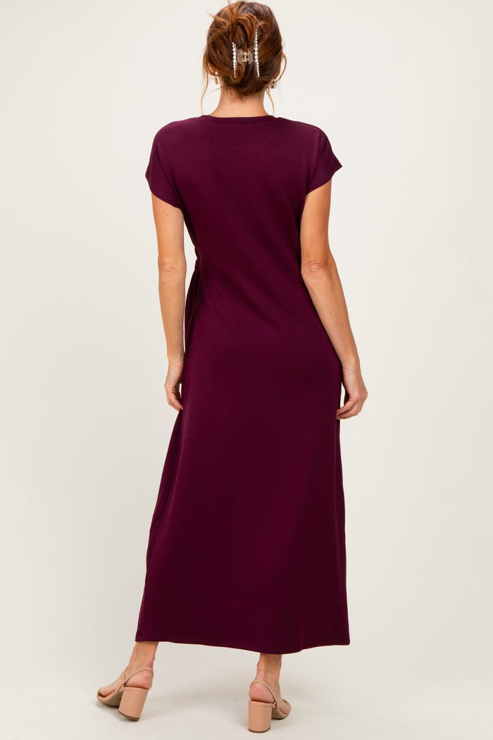 woman wearing a burgundy maxi dress with short sleeves, view from the back