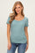 woman wearing a teal striped short sleeve top with a scoop neckline and a relaxed fit, paired with jeans