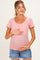 woman wearing a pink striped maternity top and holding her baby bump while smiling