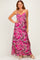 woman wearing a pink floral maxi dress with adjustable spaghetti straps and a flowy silhouette