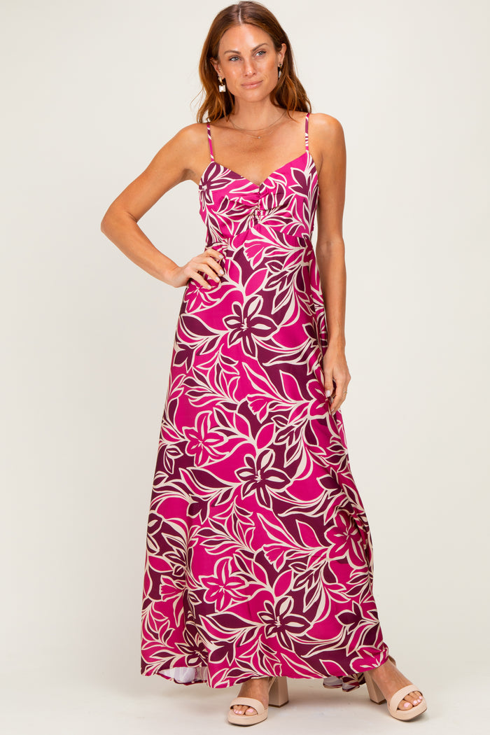woman wearing a pink floral maxi dress with adjustable spaghetti straps and a flowy silhouette