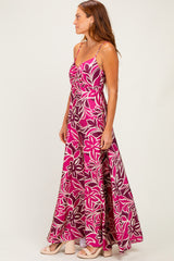 woman wearing a pink floral maxi dress with spaghetti straps and a flowing skirt