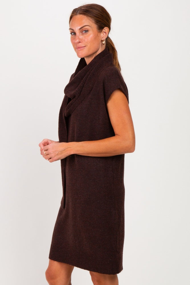 woman wearing a brown sleeveless sweater dress with a cowl neck and relaxed fit