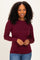 woman wearing a maroon long sleeve top with a scoop neckline and styled hair