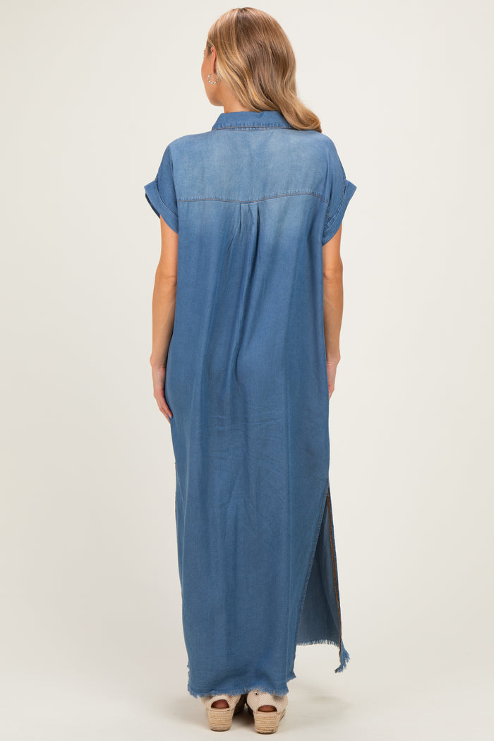 woman wearing a long denim shirt dress with short sleeves and high side slits, showing the back view