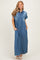 woman wearing a short sleeve blue denim maxi dress with button details and side pockets