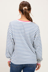 woman wearing a light blue and white striped maternity top with pink accents, showing a relaxed fit from the back