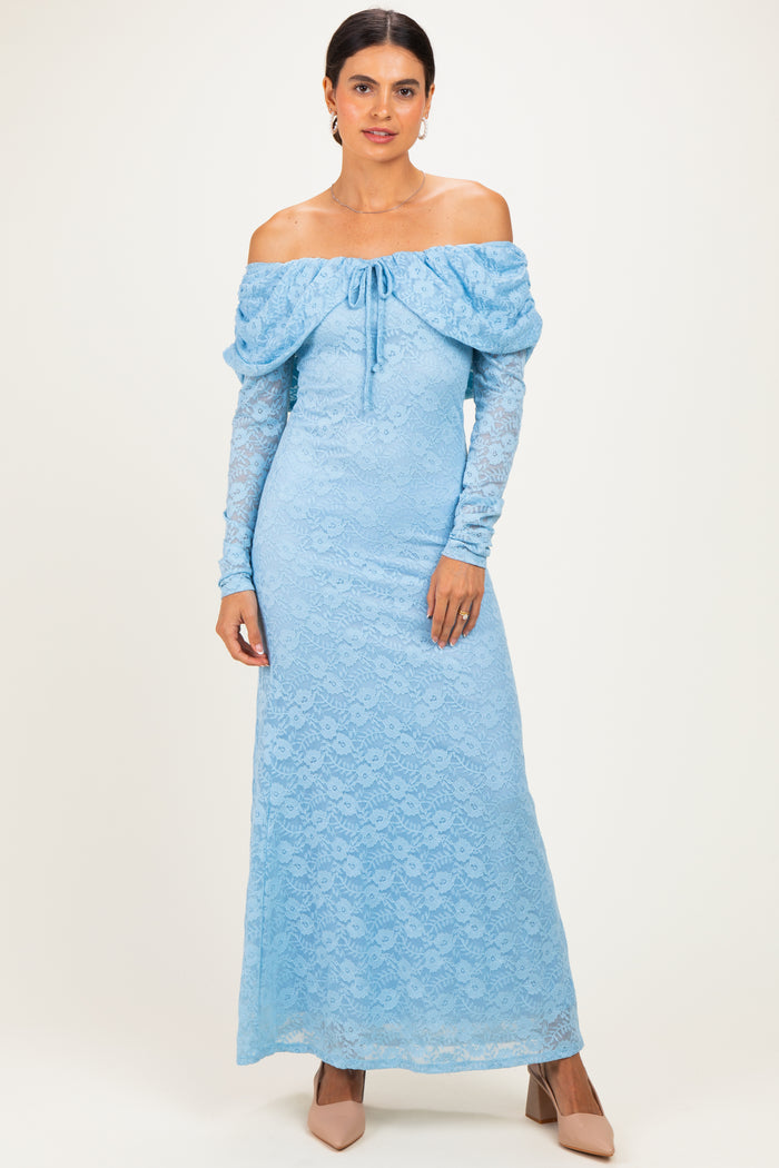 woman wearing a sky blue off-the-shoulder lace maxi dress with long sleeves and a tie detail at the neckline
