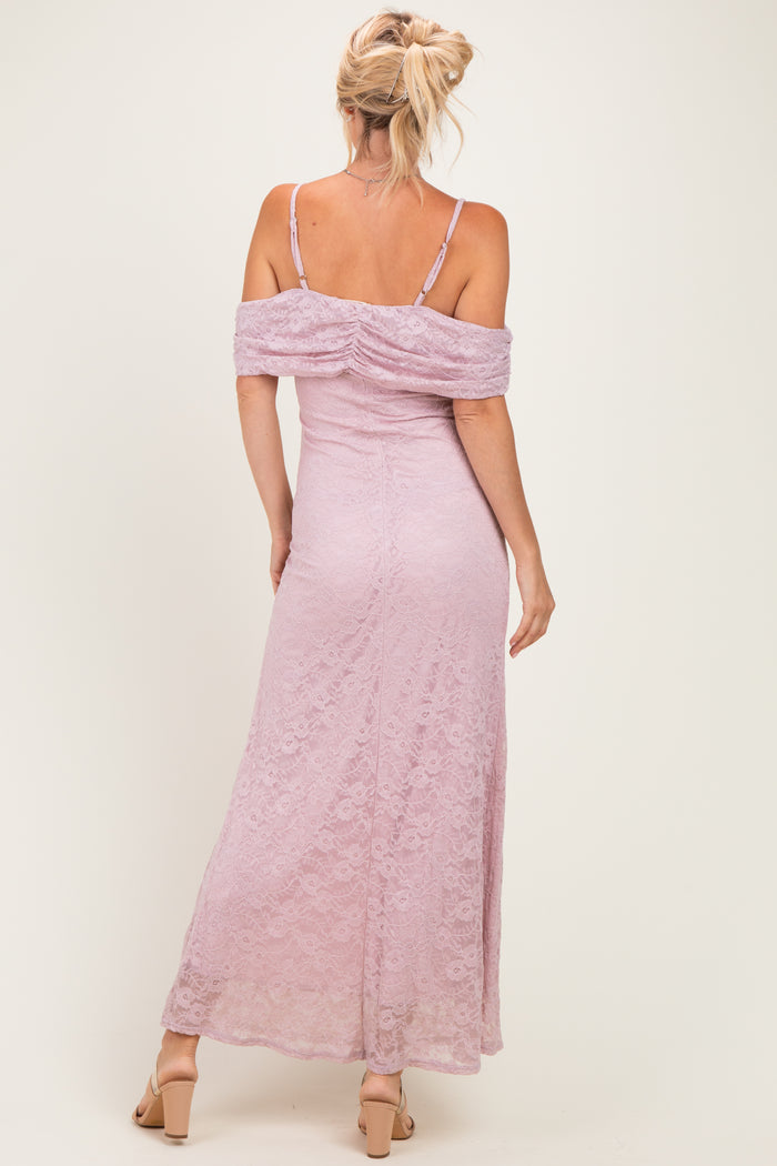 woman wearing a lavender lace off-the-shoulder maxi dress with a fitted silhouette and a ruched back design