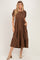 woman wearing a brown tiered maxi dress with puff sleeves and pockets