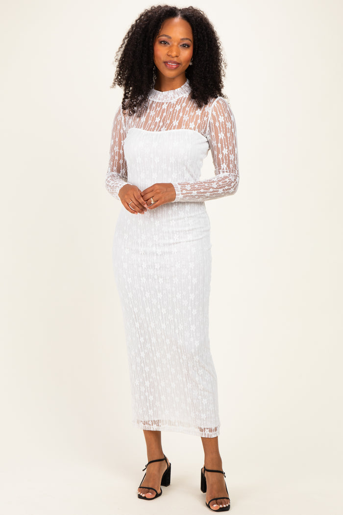 woman wearing a white lace long sleeve midi dress with a fitted silhouette and sheer details