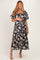 woman wearing a navy floral maternity maxi dress and holding her baby bump