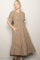 woman wearing a brown floral midi dress with puff sleeves and pockets, standing against a neutral background